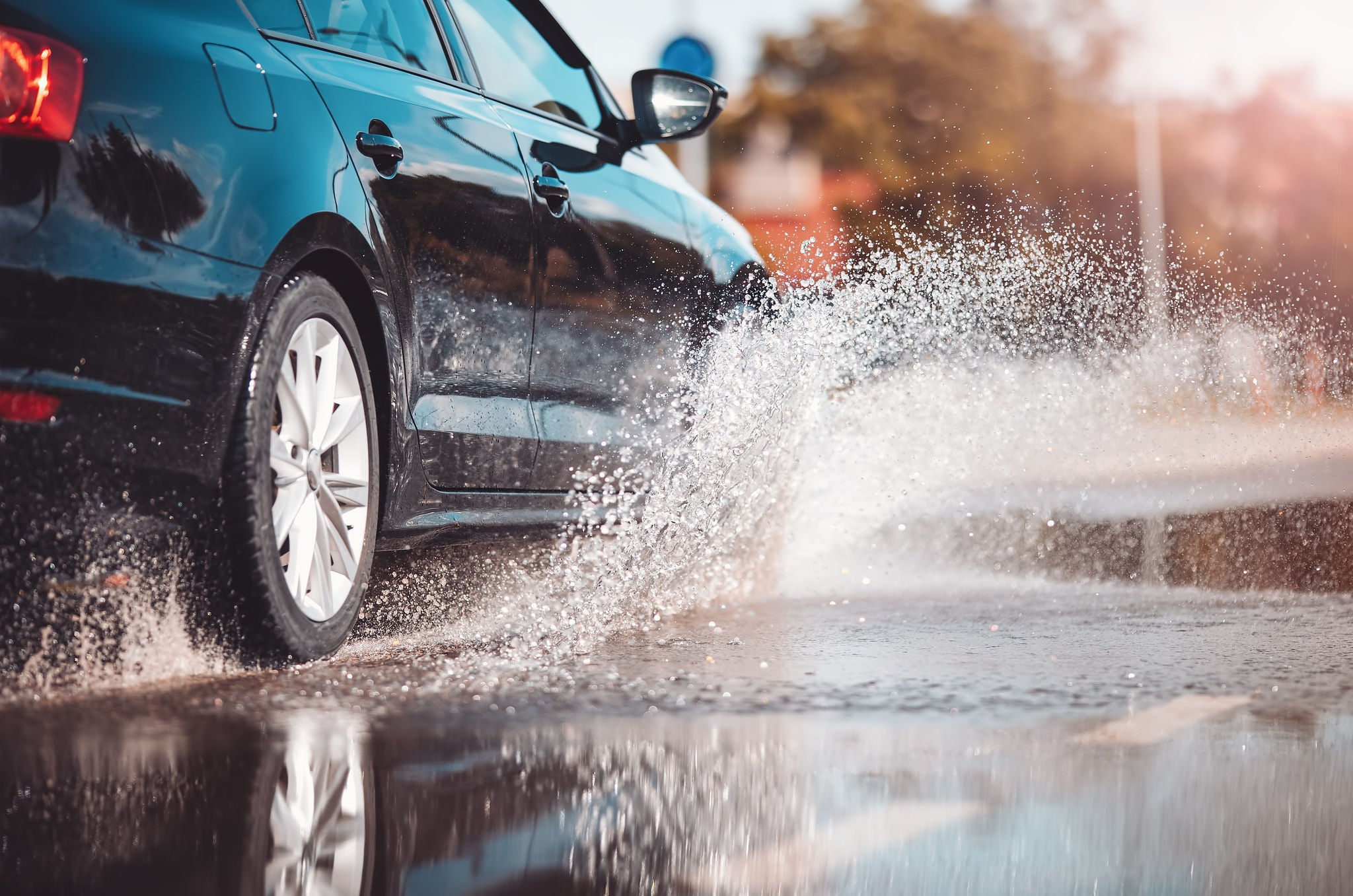 Uniroyal - Car driving through the puddle and splashing by water. 