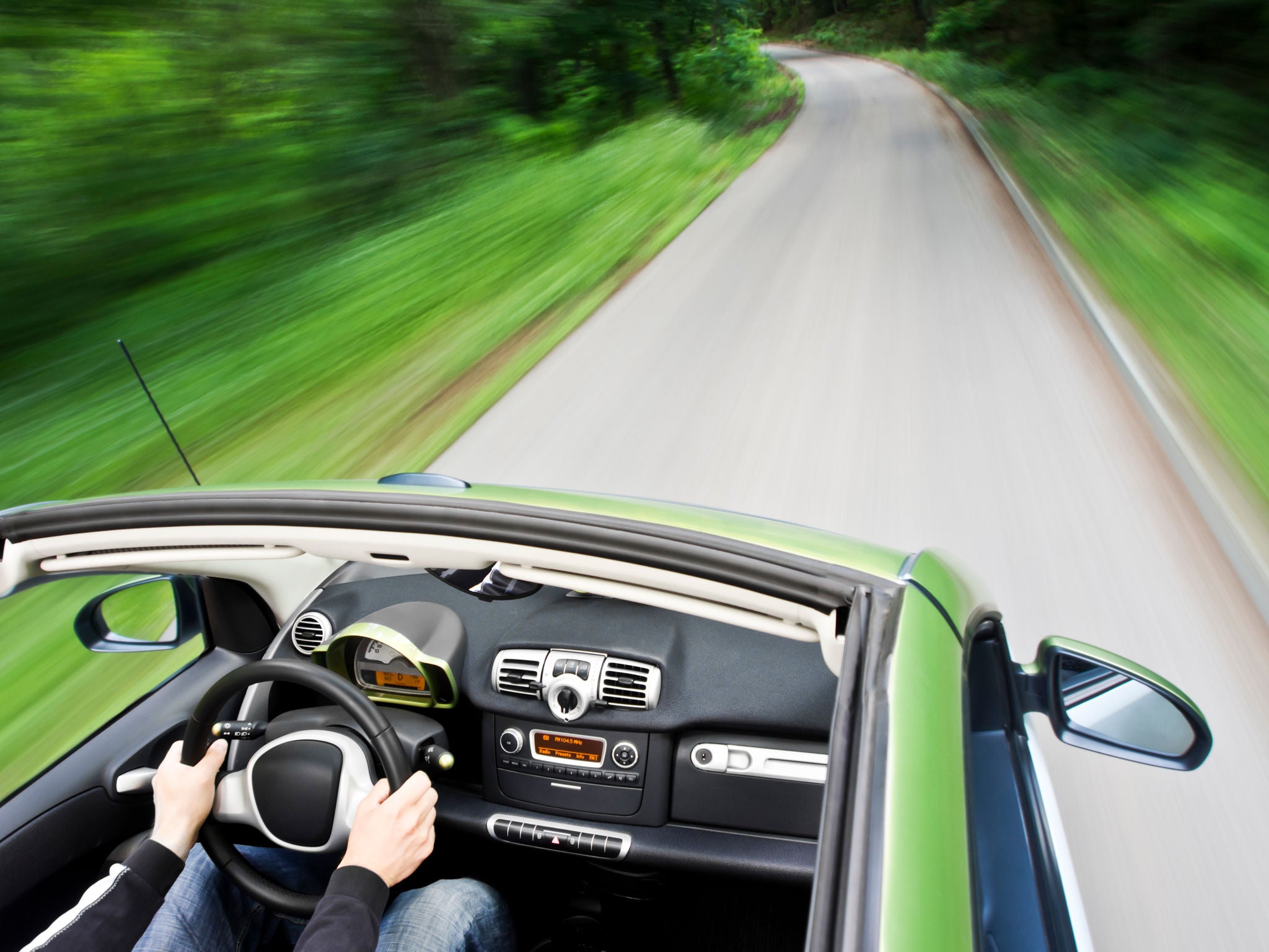 Uniroyal - Motion blur shot of a man driving electric car on the mountain road.