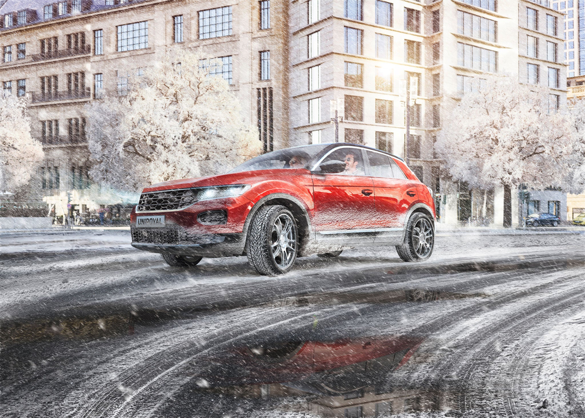 Red SUV driving on snowy city roads on Uniroyal WinterExpert tyres