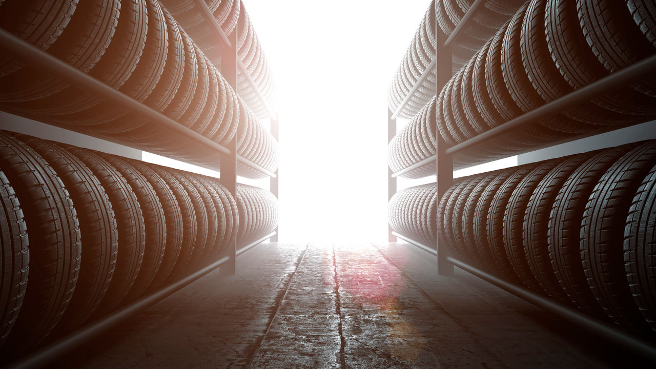 Uniroyal - Car tires rack in workshop background, back lit