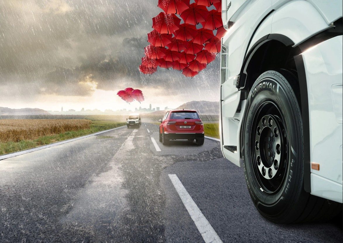 Uniroyal RainSport 5 tyre on a red car driven by a male person in a city